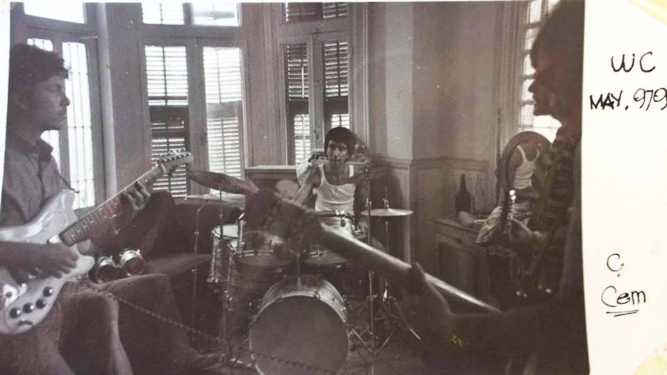 old film photo with three members of the band rehearsing