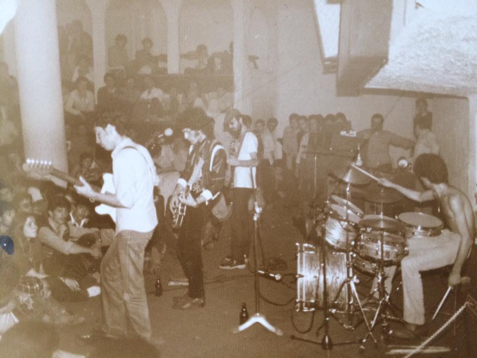 old film photo with the full band performing infront of a large group